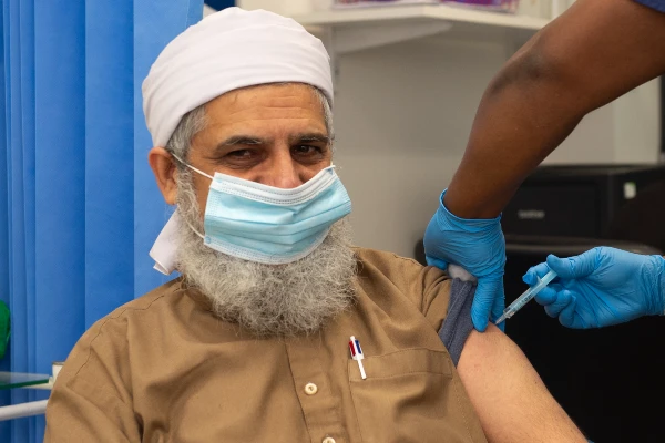 A patient receiving a vaccination at Lordship Lane Vaccination Clinic