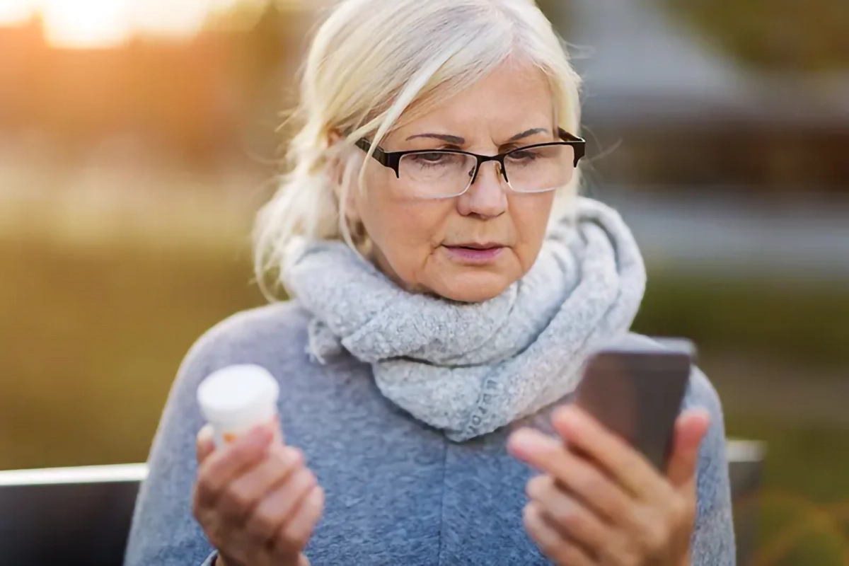 image depicting an woman holding medication